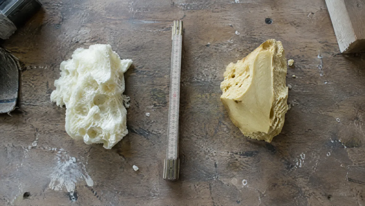 Two spray foam samples compared on a workbench